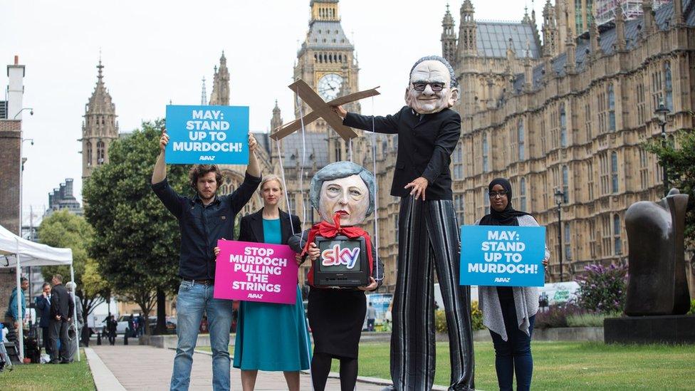 Campaigners from Avaaz dressed as British Prime Minister Theresa May and Australian media Mogul Rupert Murdoch in London in June