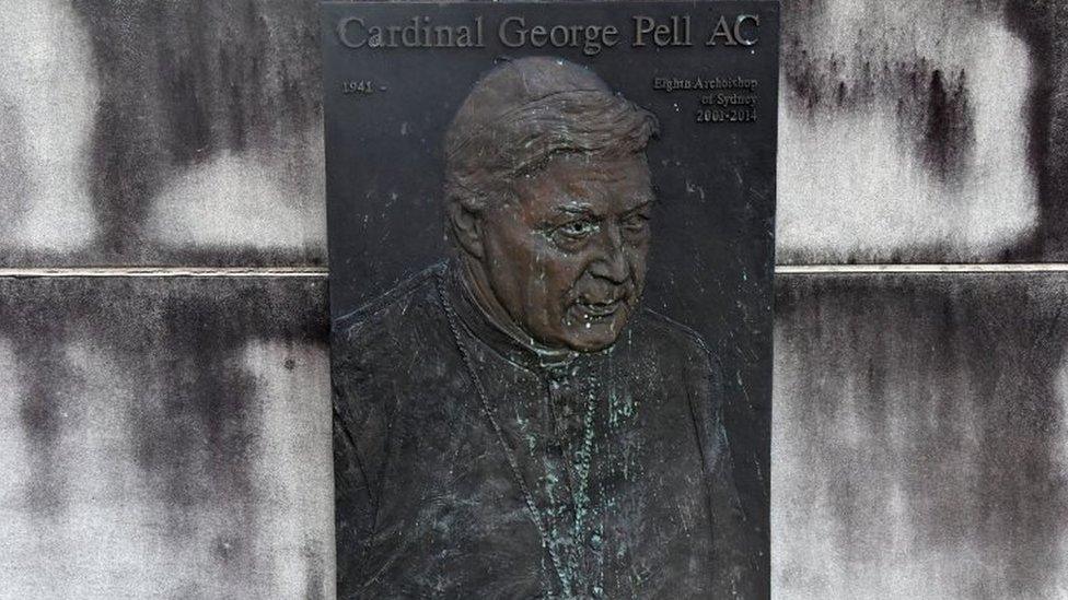 A faded plaque depicts George Pell below the words: "Cardinal George Pell AC"