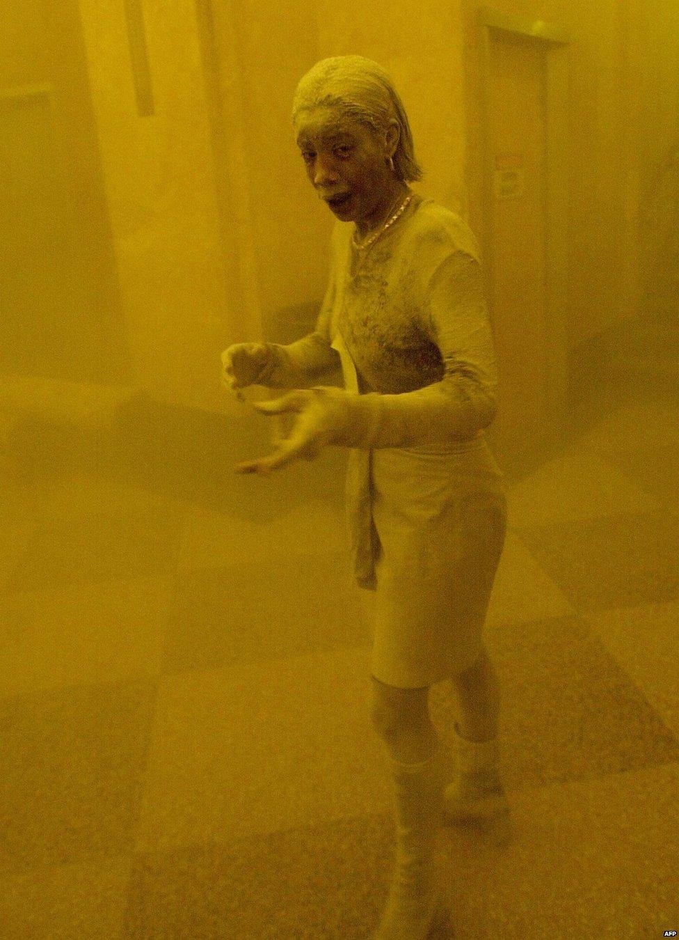 Marcy Borders covered in dust as she takes refuge in an office building after one of the World Trade Center towers collapsed in New York, September 11th 2001.