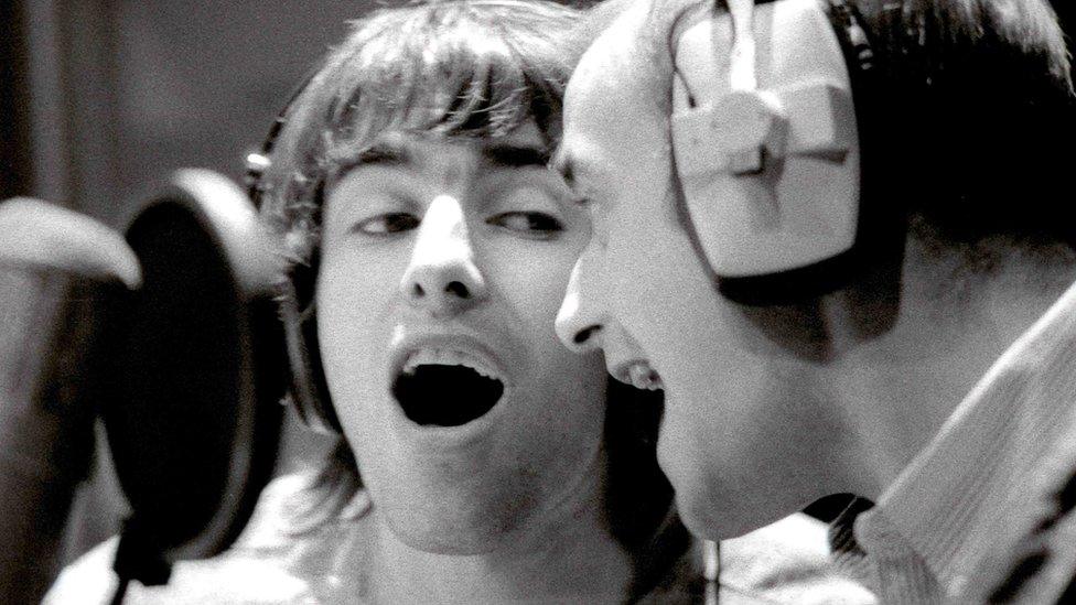 Liam Gallagher singing with Bonehead