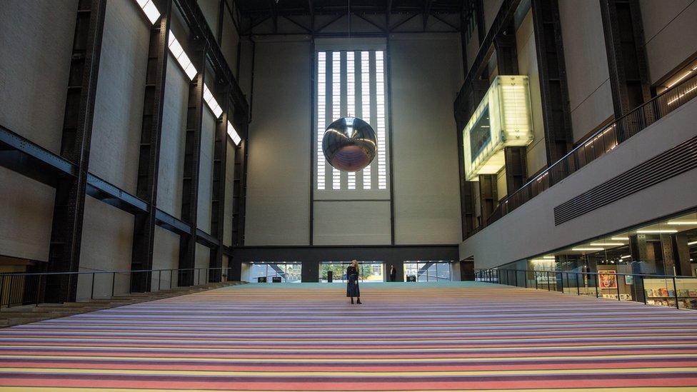 Woman on carpet looking at pendulum