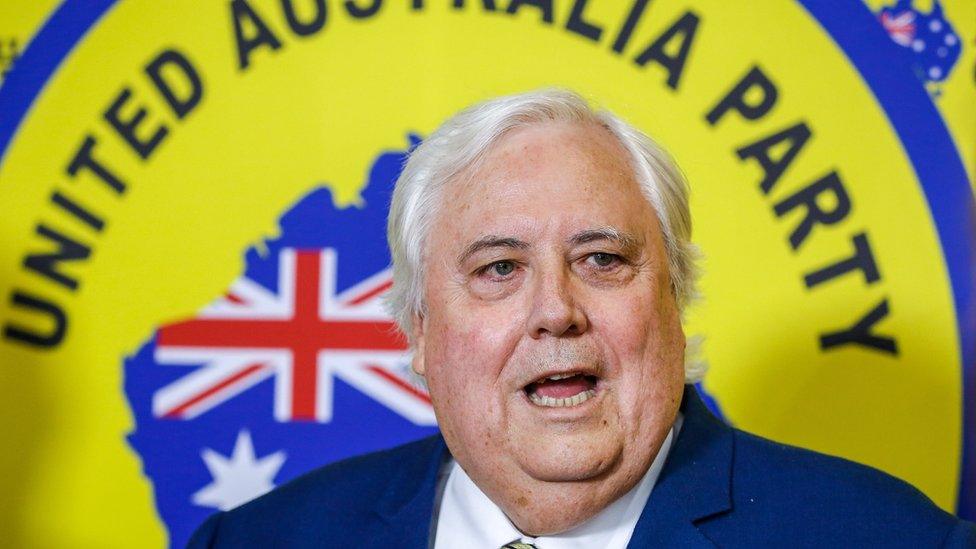 Clive Palmer speaking in front of a United Australia Party backdrop