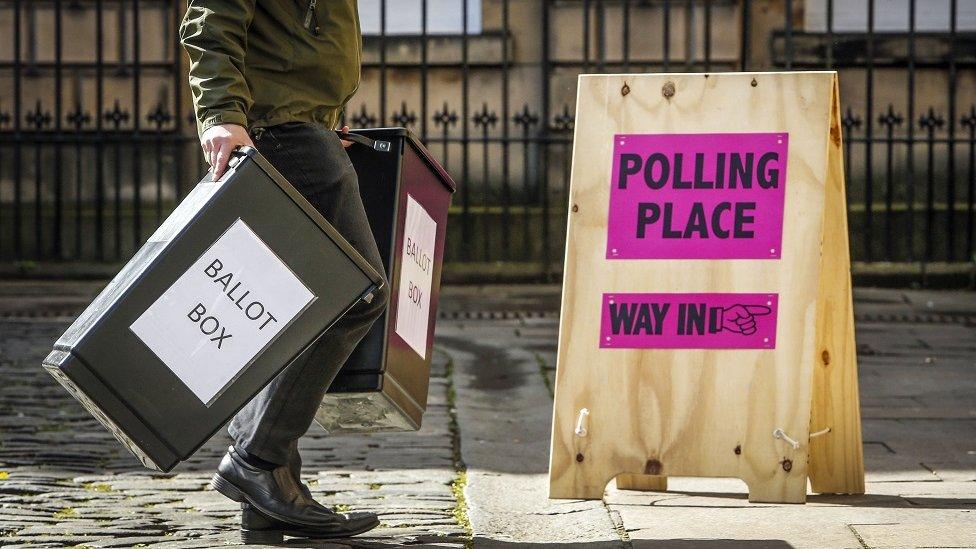 Man carrying ballot boxes