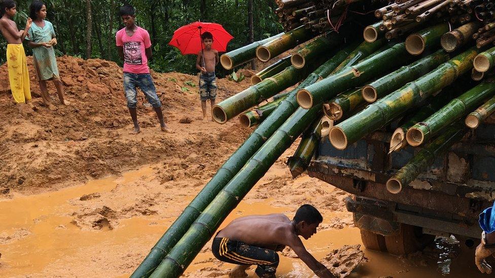 A truck tries to get through the mud caused by the monsoon