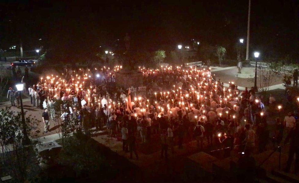 White nationalists carry torches around a statue of Thomas Jefferson on the grounds of the University of Virginia