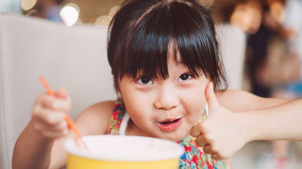 Child eating yoghurt.