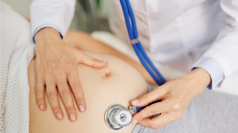 Doctor checking pregnant woman