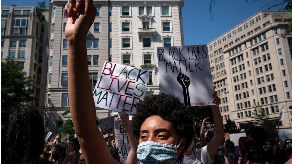 Demonstrators peacefully protest outside of Trump International Hotel Washington