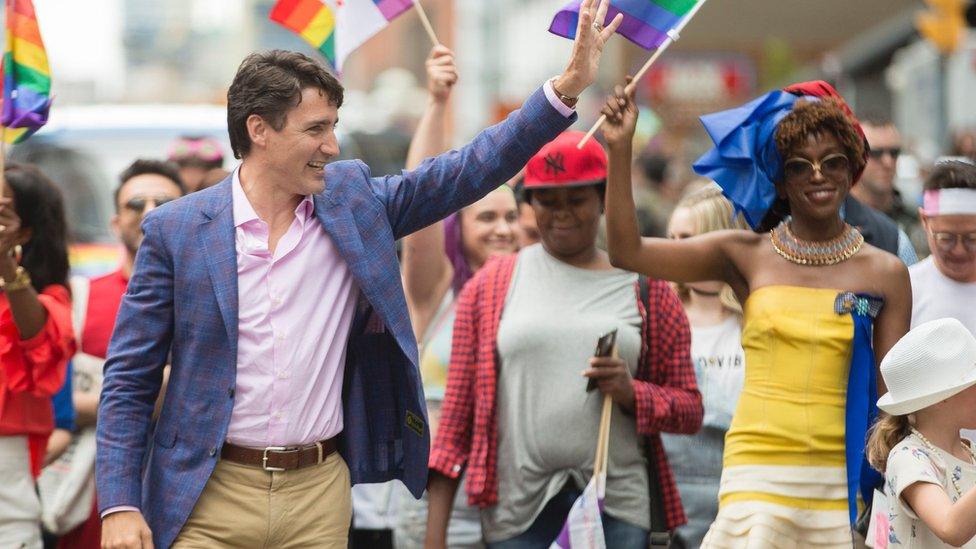 Prime Minister Justin Trudeau waves to the crowd as he marches in the Pride Parade in Toronto, June 25, 2017