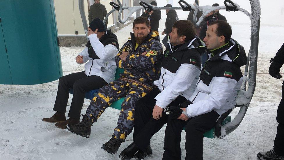 Ramzan Kadyrov and three others sit in a chairlift of the ski resort