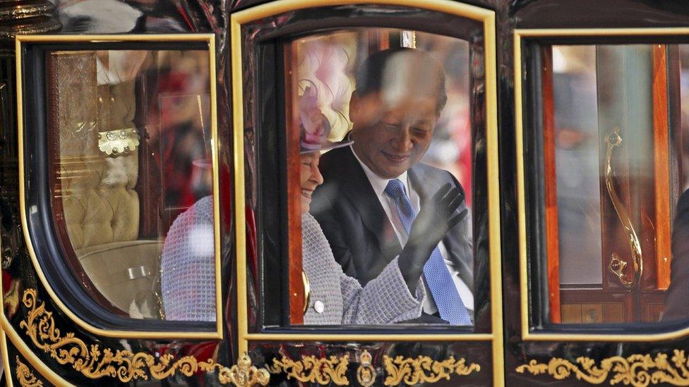 Britain's Queen Elizabeth and the Chinese President Xi Jinping are driven by carriage to Buckingham Palace in London