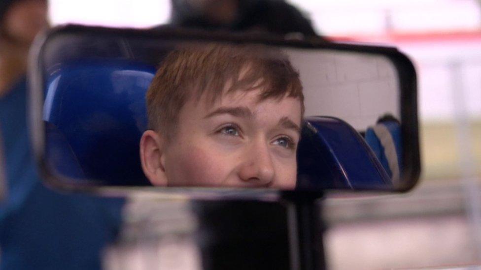 Billy Monger looking into his mirror