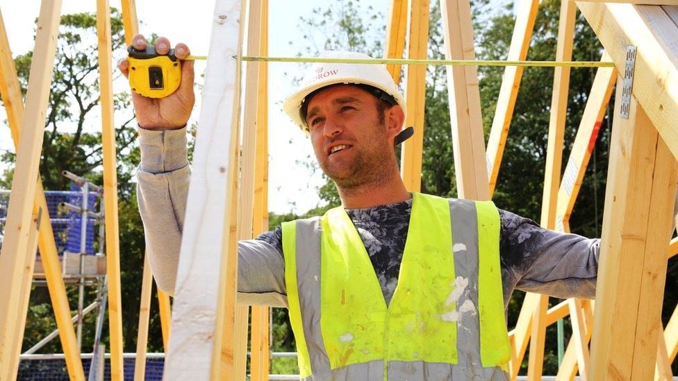 A builder working on a house