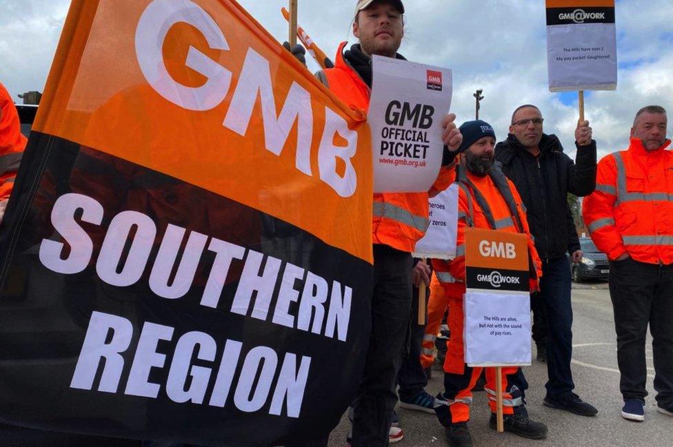 GMB refuse workers on strike holding the GMB southern region flag