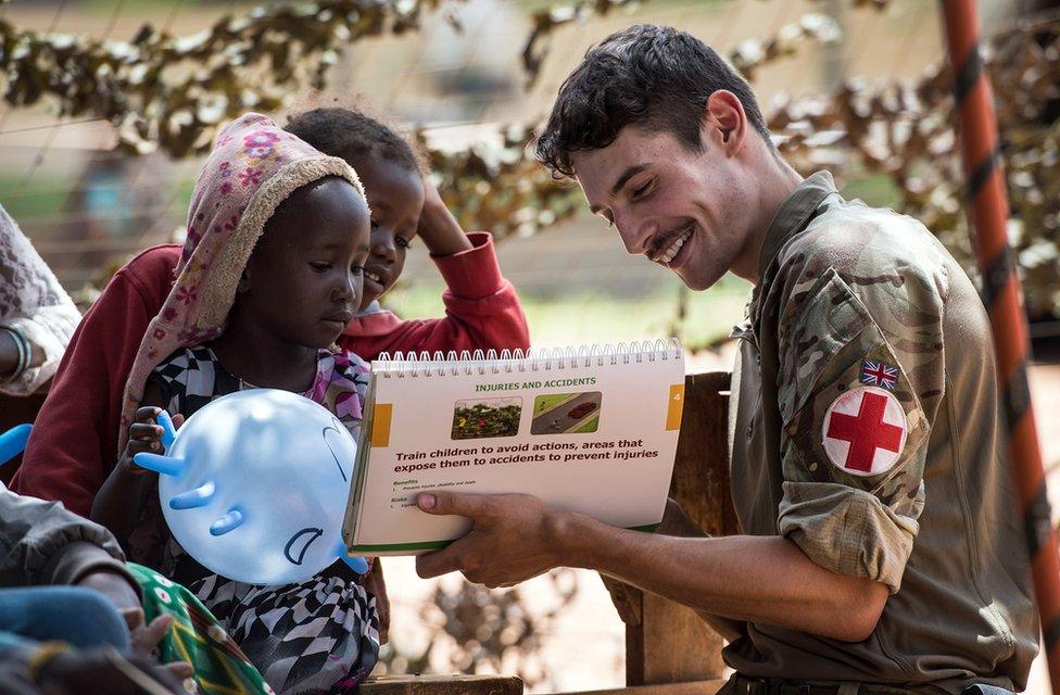 A soldier with two children