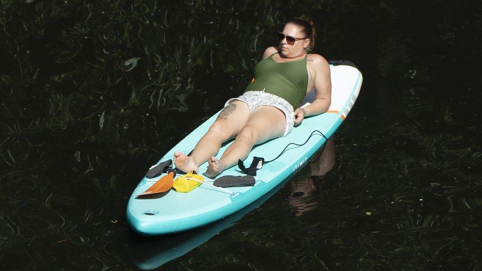 A paddle boarder enjoys the hot weather on the River Nidd in Knaresborough, North Yorkshire