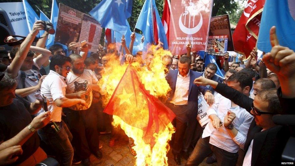 Demonstrators set fire to a Chinese flag