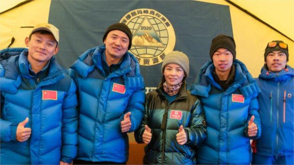 Members of Chinese surveying team pose for photos at a Everest Base Camp on May 10, 2020 in Shigatse