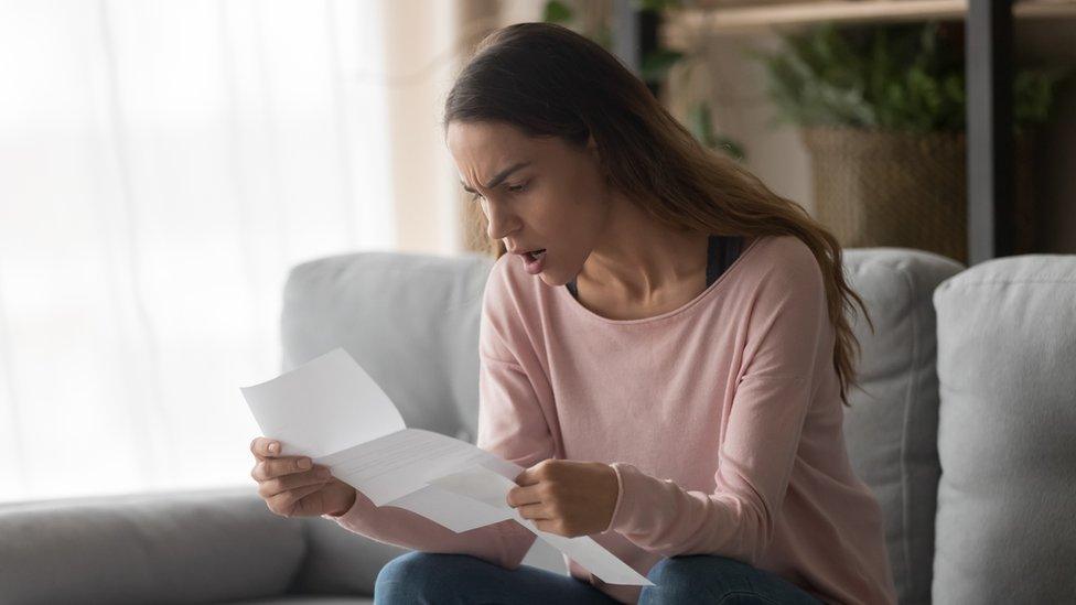 Woman looking at bill