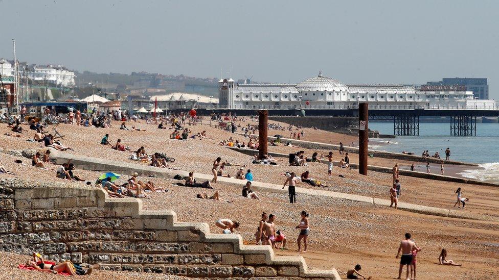 People are seen on Brighton beach following the outbreak of the coronavirus disease (COVID-19), Brighton, Britain