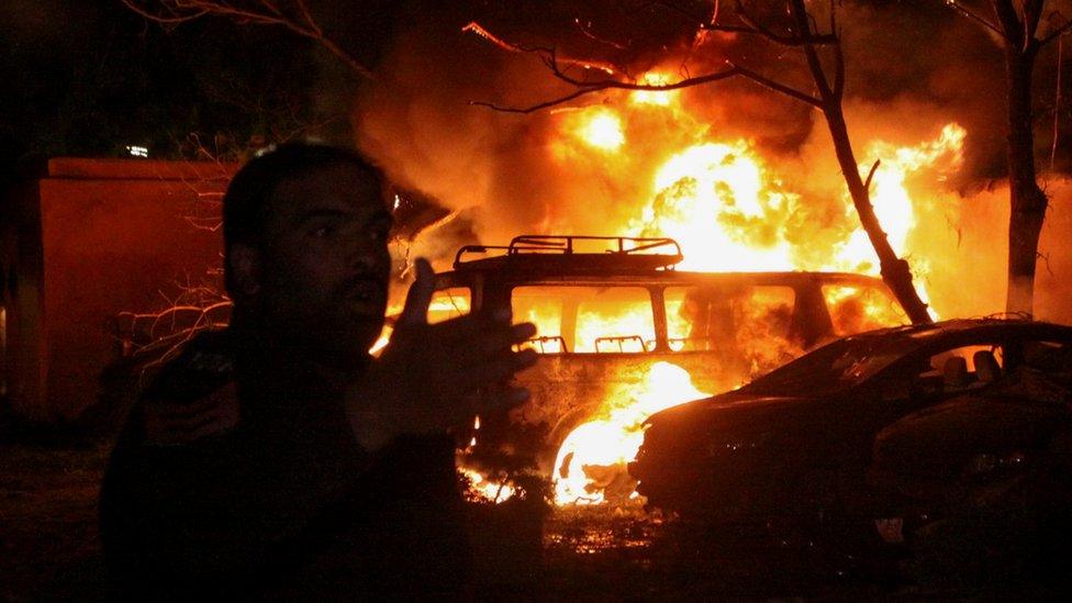 A police officer reacts after an explosion at a luxury hotel in Quetta, Pakistan