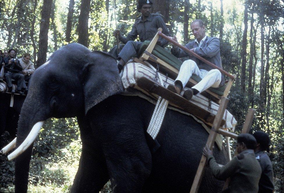 Prince Philip, Duke of Edinburgh rides an elephant during a visit to the Kanha game reserve on 21 November 1983 in in India.