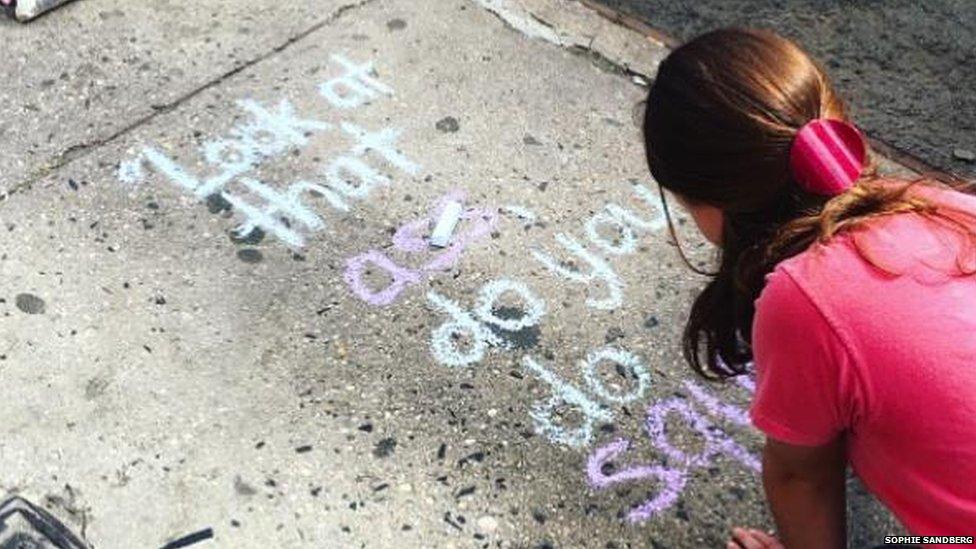 Sophie Sandberg in New York writing on the pavement