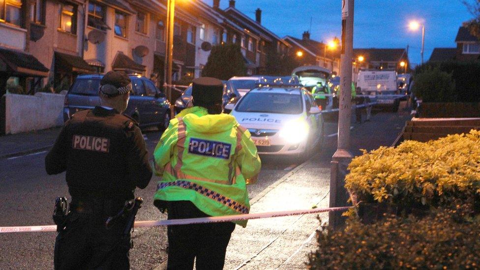 Police officers and vehicles at the scene of the incident in Newtownabbey