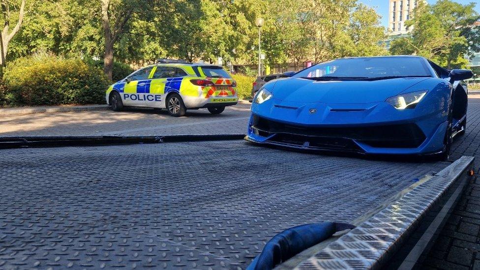 Lamborghini being loaded on a truck