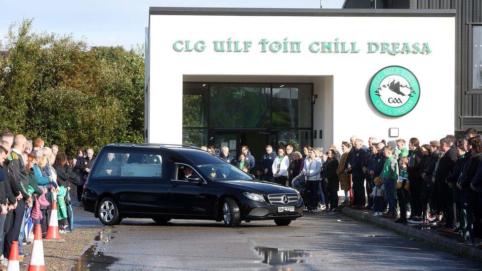 A hearse carrying Ronan Wilson's coffin outside his GAA club