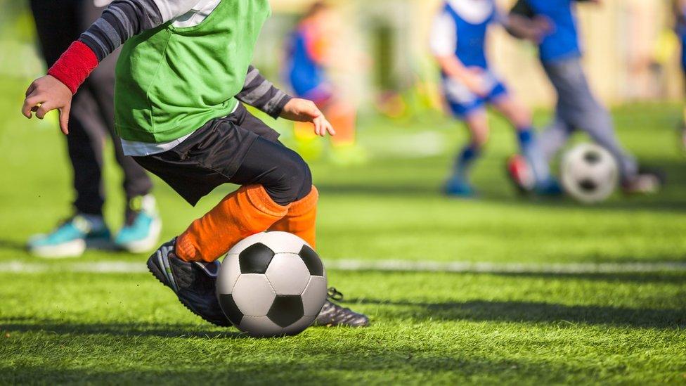 child playing football