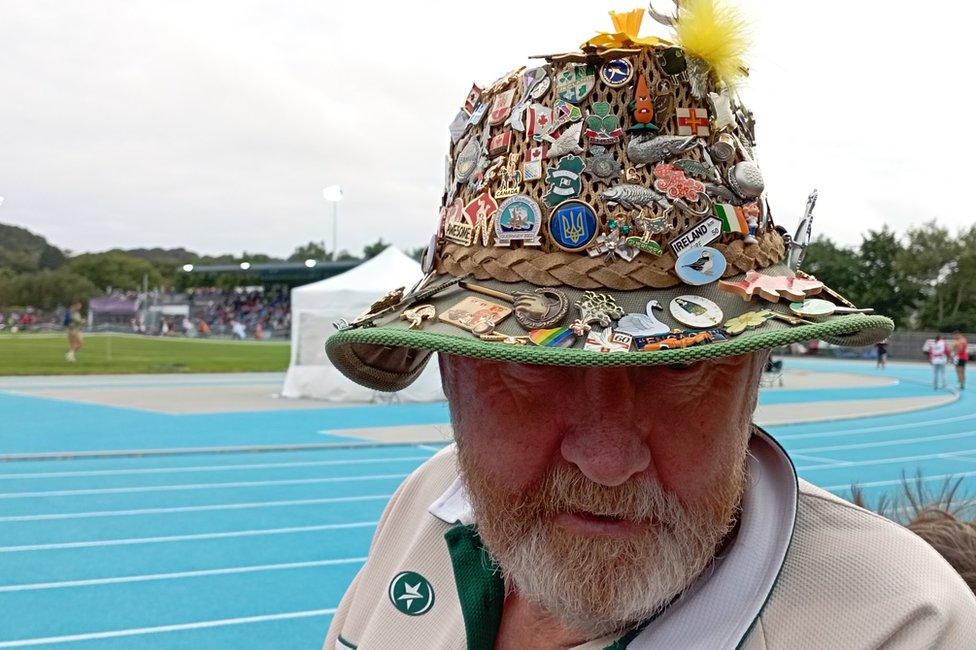 Man with hat full of pin badges