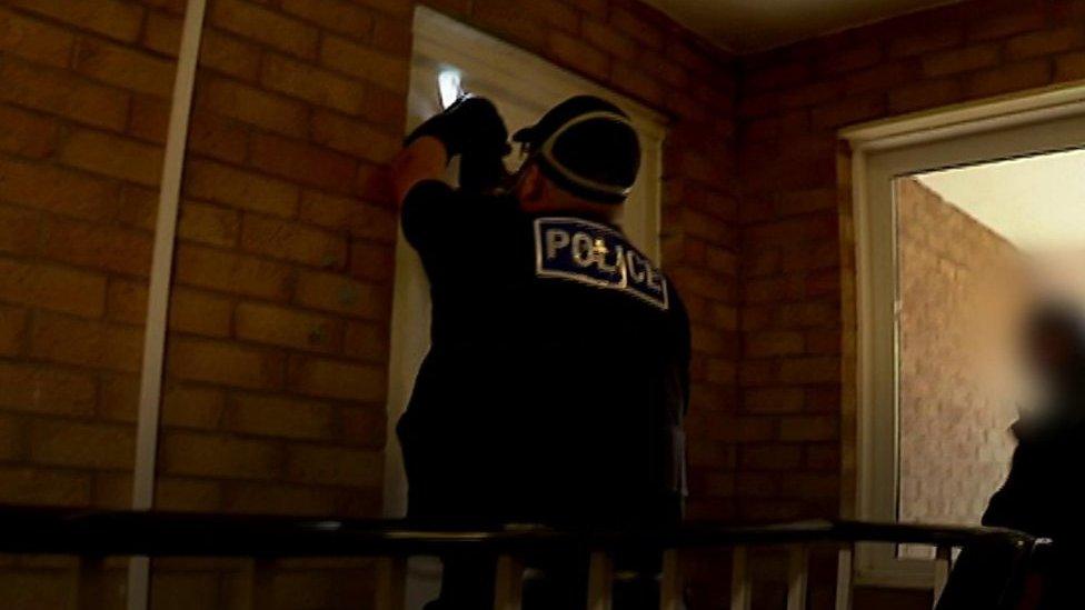 Police entering a house