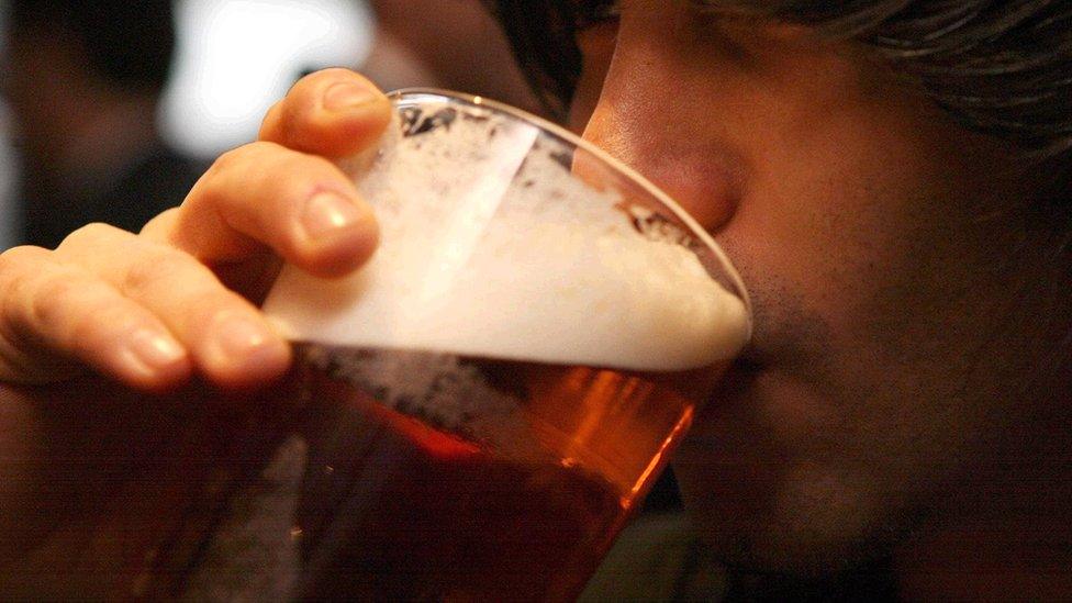 Man drinking pint of beer