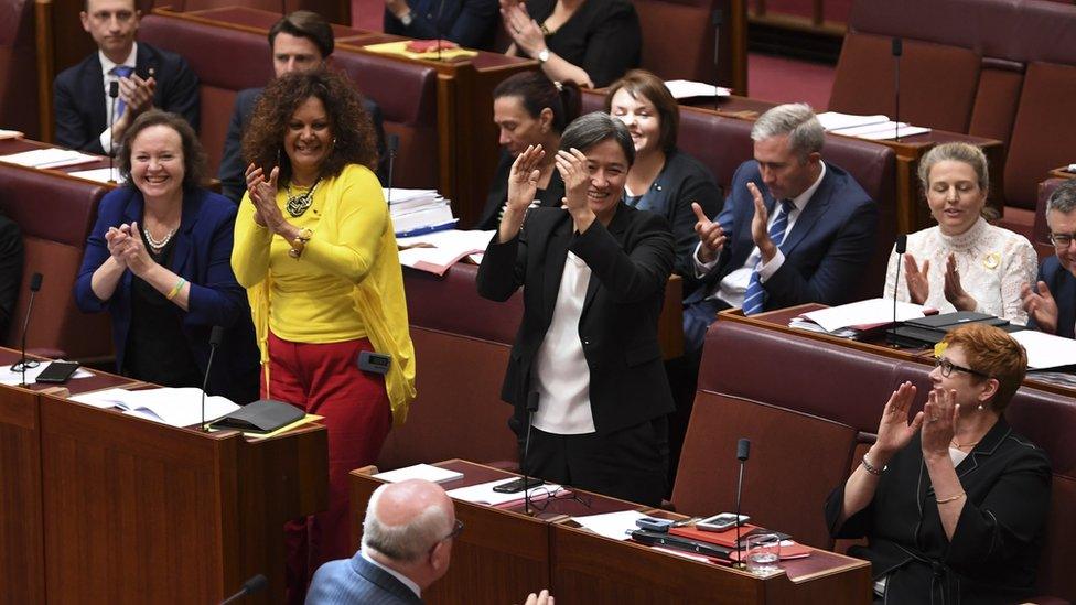 Australian senators celebrate the passage of the same-sex marriage bill