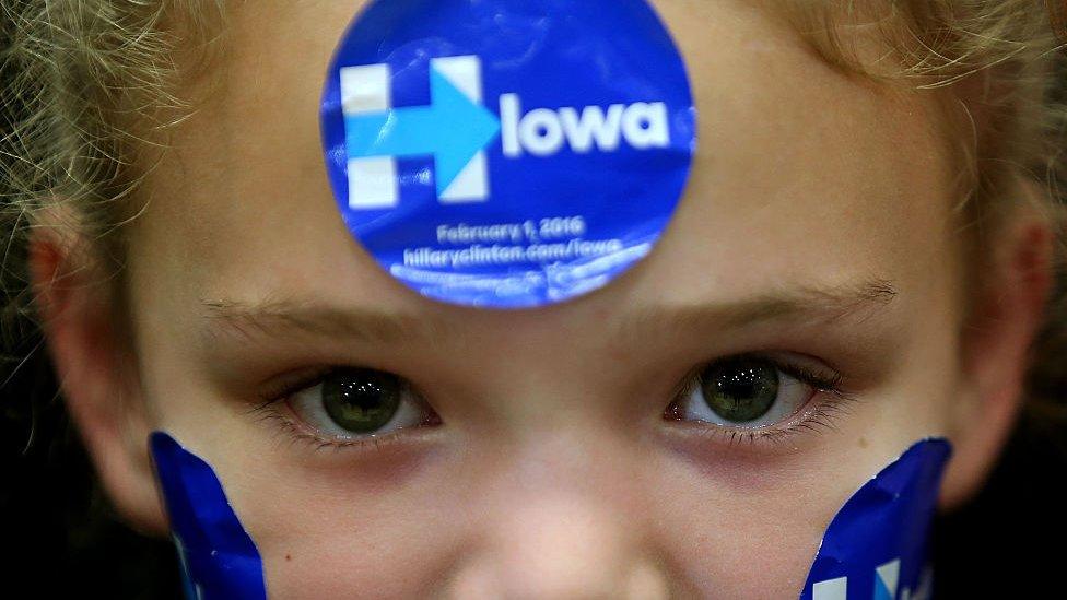 A young supporter wears campaign stickers on her face as democratic presidential candidate former Secretary of State Hillary Clinton