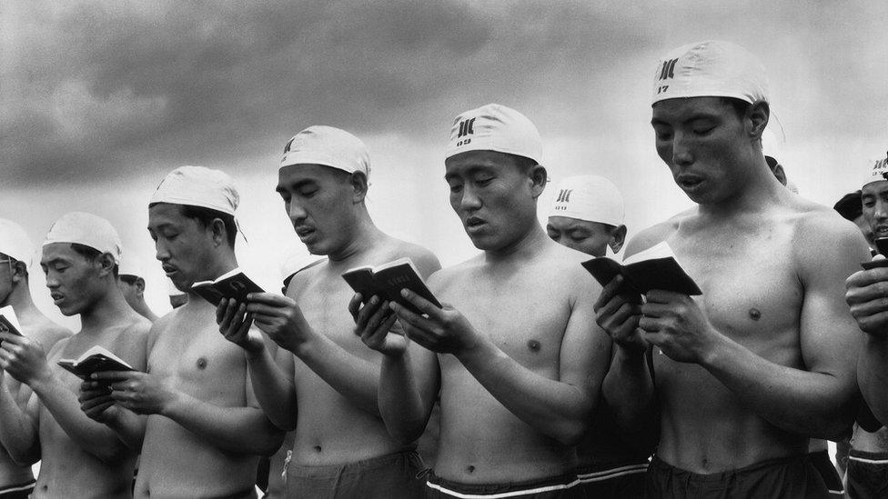 Swimmers reading the little red book