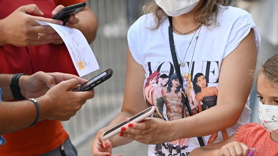 woman shows phone at Vatican