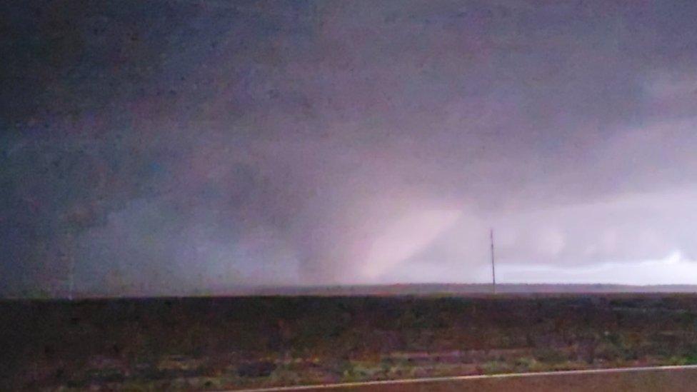 A photo of the tornado taken by a storm watcher as it rolled in