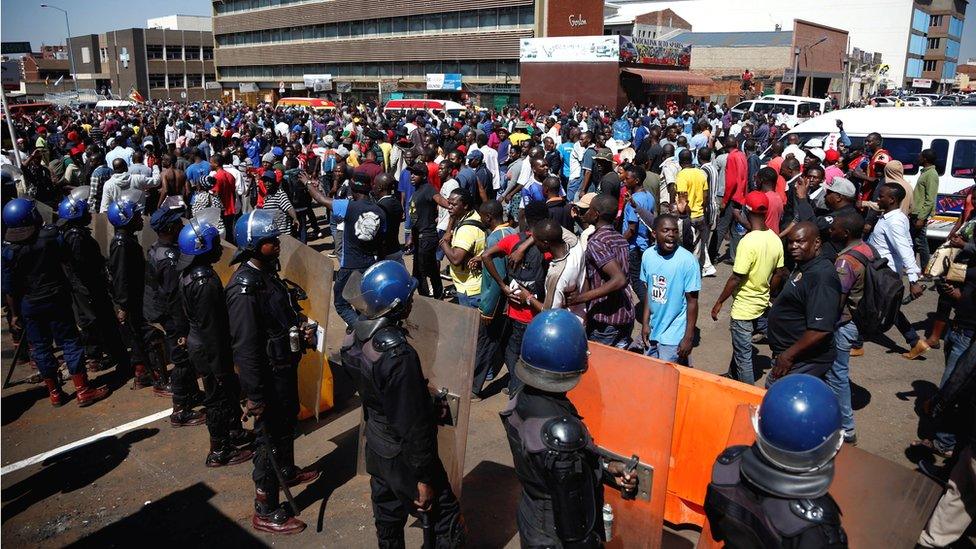 Supporters of the Movement for Democratic Change (MDC) opposition party of Nelson Chamisa sing and dance as they march in the streets of Harare, 1 August 2018