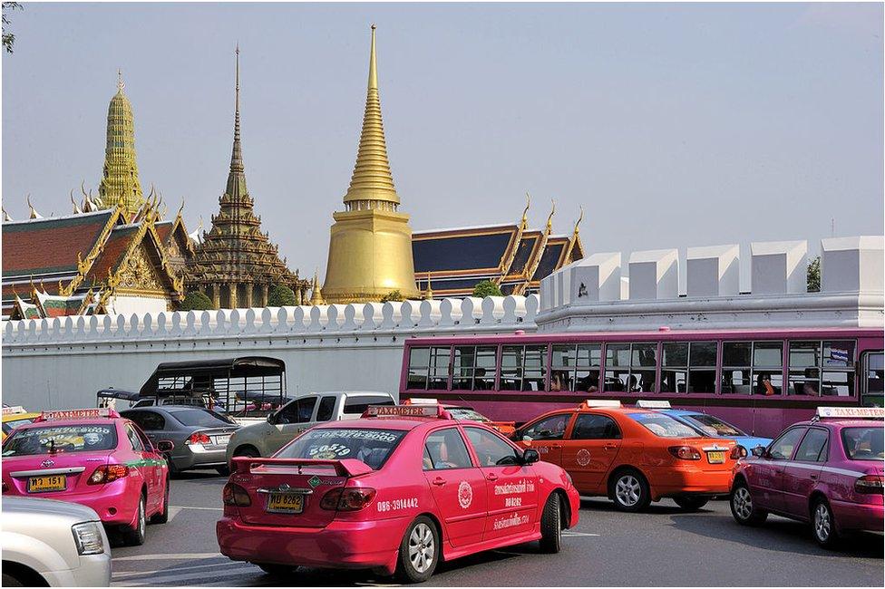 This picture taken on 19 March 2011 in Bangkok shows cars and buses parked near the Royal Palace.