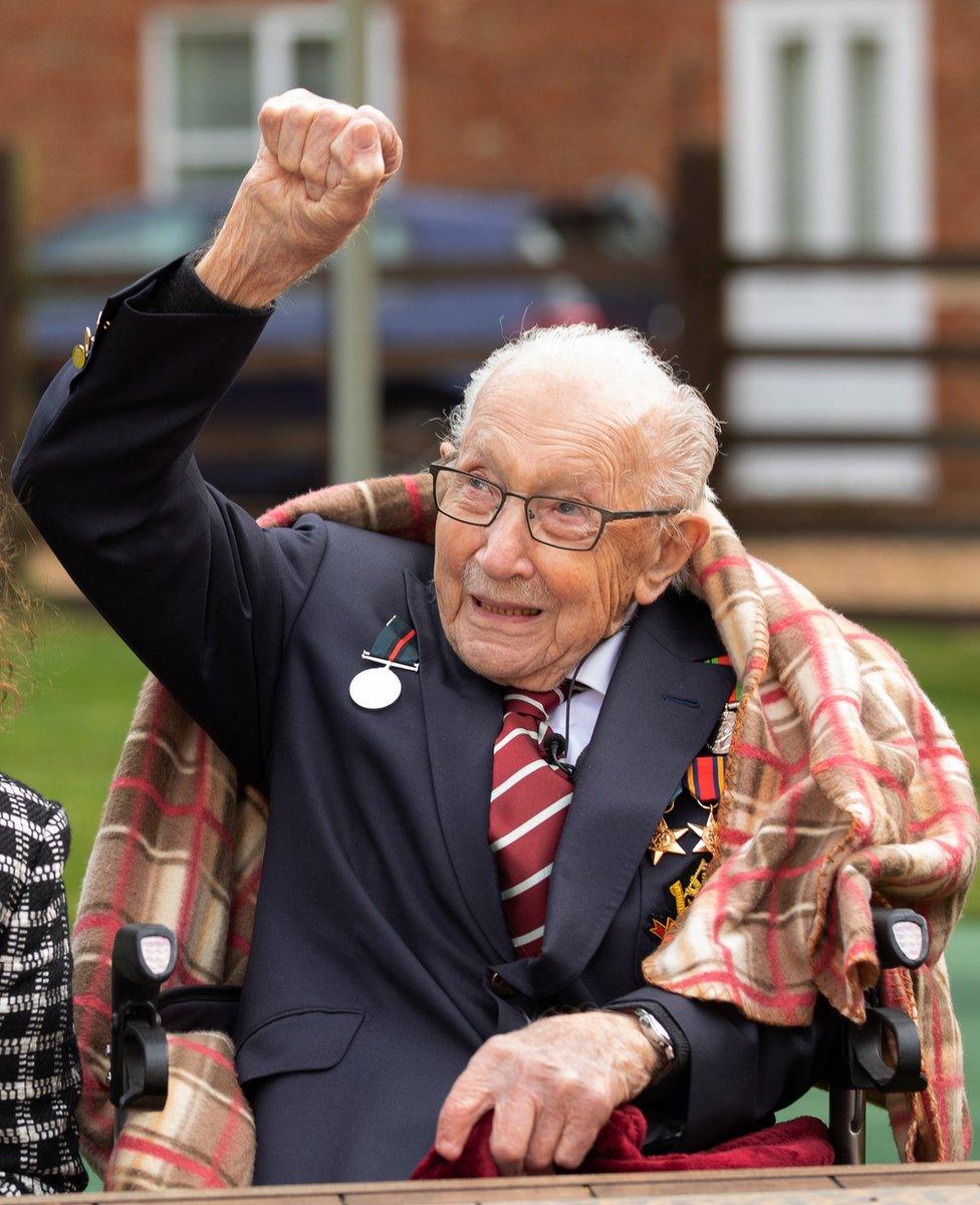 Captain Sir Tom Moore waves at an RAF flypast