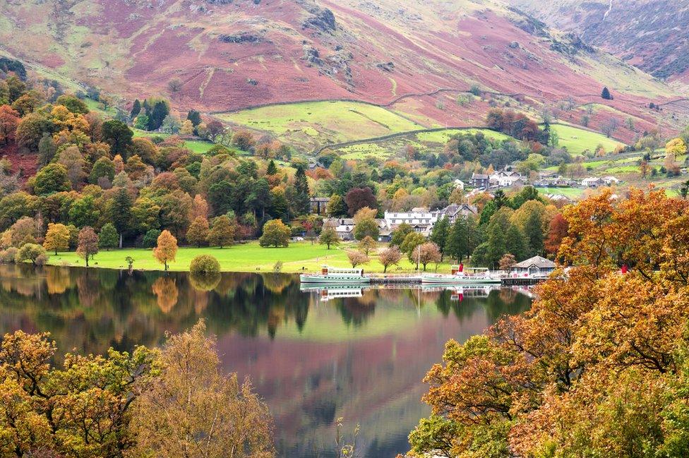 Boats and hills reflected on a lake