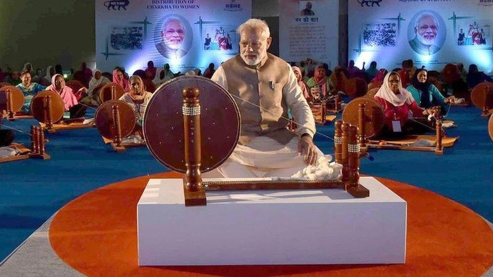 Mr Modi with traditional cotton spinning wheel