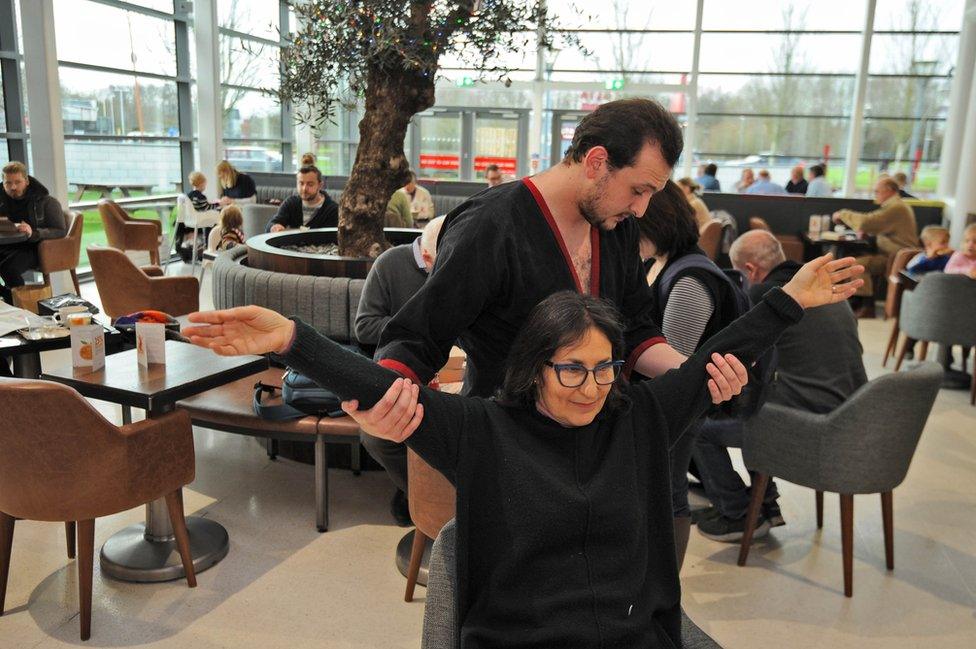 A practitioner of the Chinese martial art of Wing Tsun relaxes travellers stopping at Norton Canes services