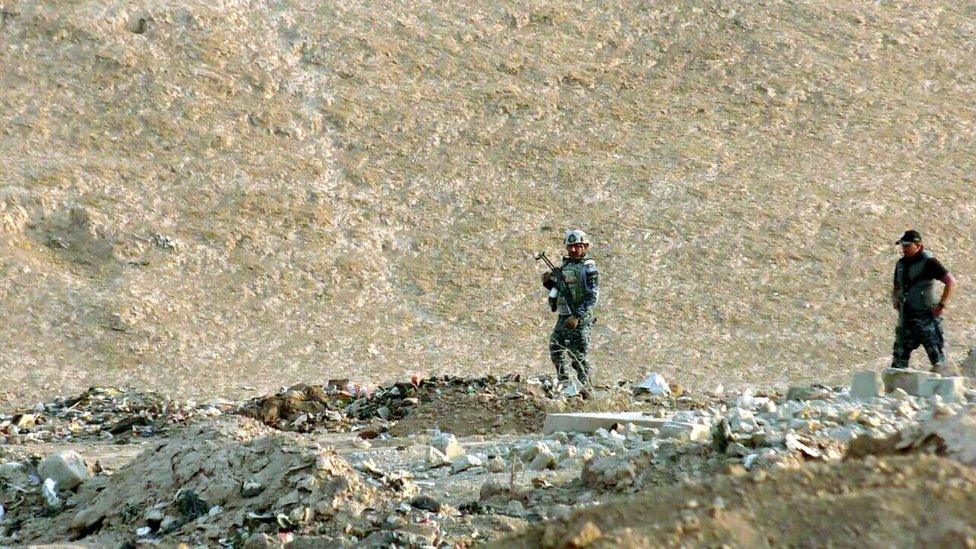 Iraqi policemen inspect the site believed to be a mass grave, in Hamam al-Alil town, southern Mosul, Iraq, 08 November 2016.