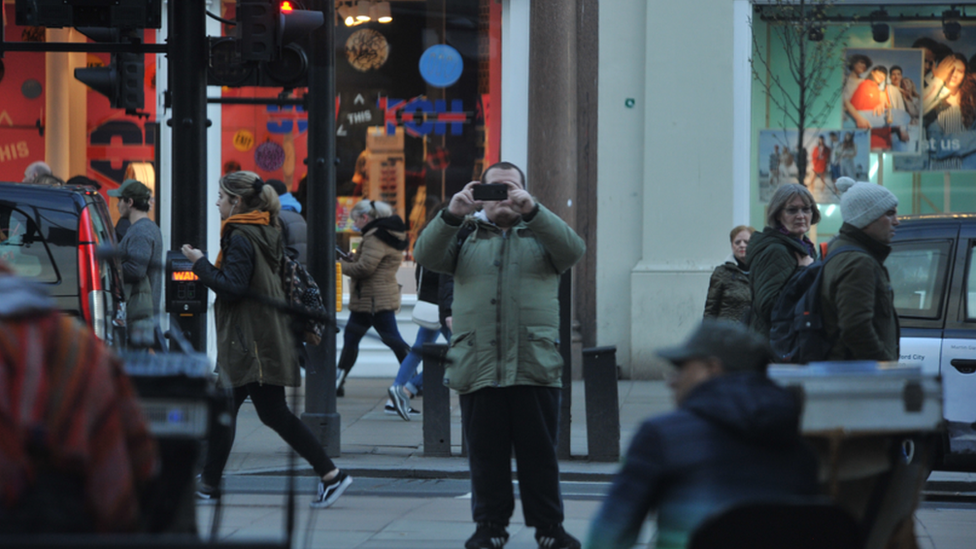 Surveillance image of Lewis Ludlow taking pictures in Oxford Street