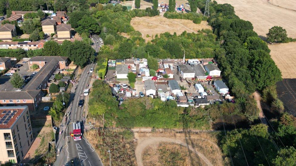 A caravan park close to a field fire