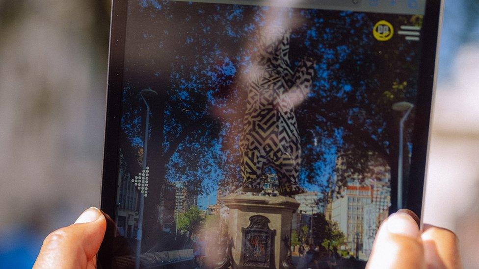 A view on an iPad of a bear sculpture on top of an empty plinth