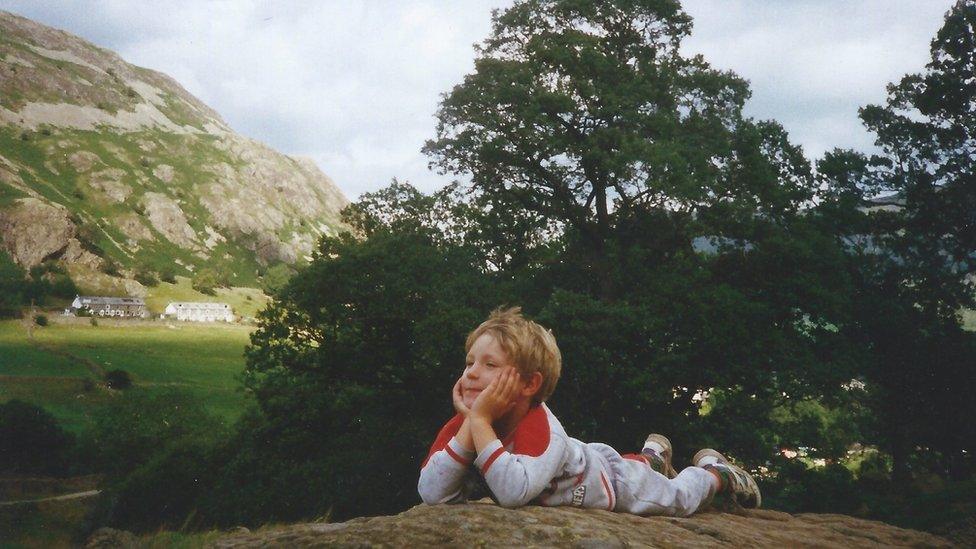 Benjamin as a child on a rock